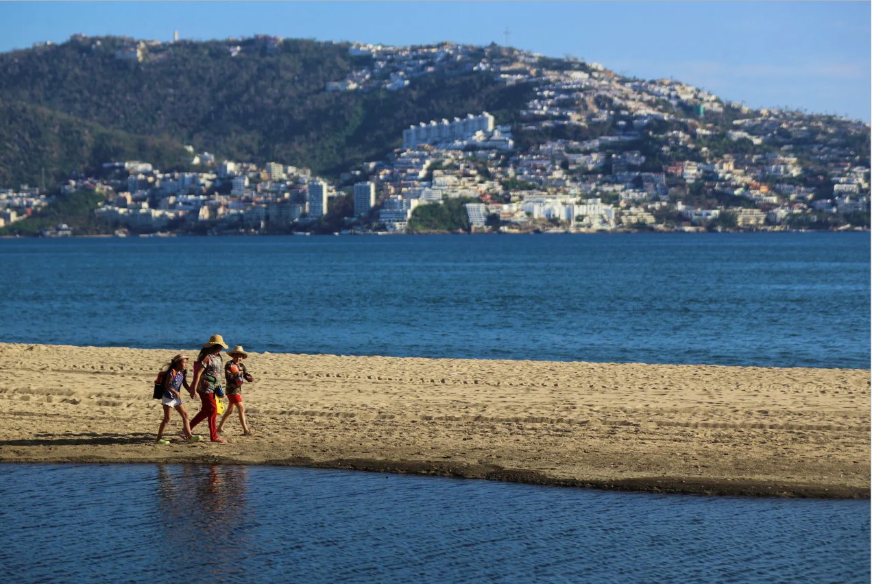 2023年11月24日，奧蒂斯颶風襲擊墨西哥阿卡普爾科一個月后，人們在海灘上行走。